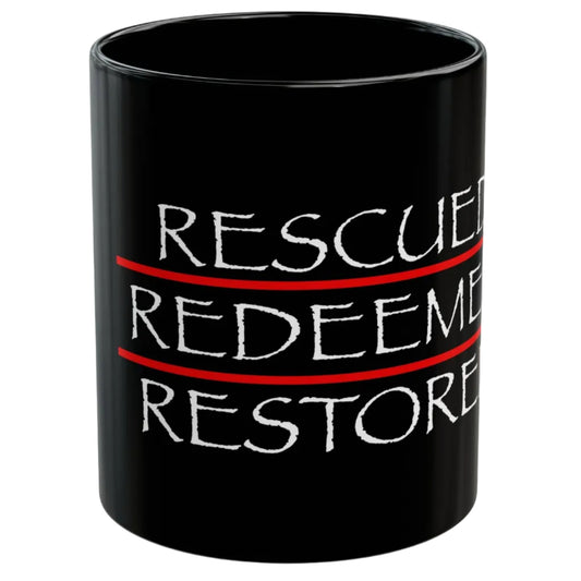 Black mug with 'Rescued Redeemed Restored' text on a white background