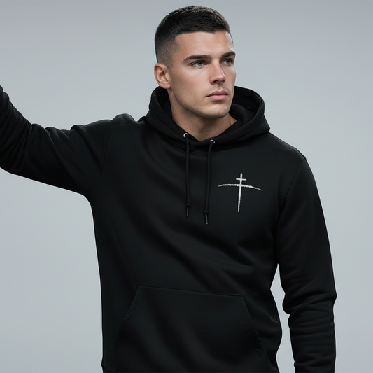 Man wearing a black hoodie with a logo in an urban setting