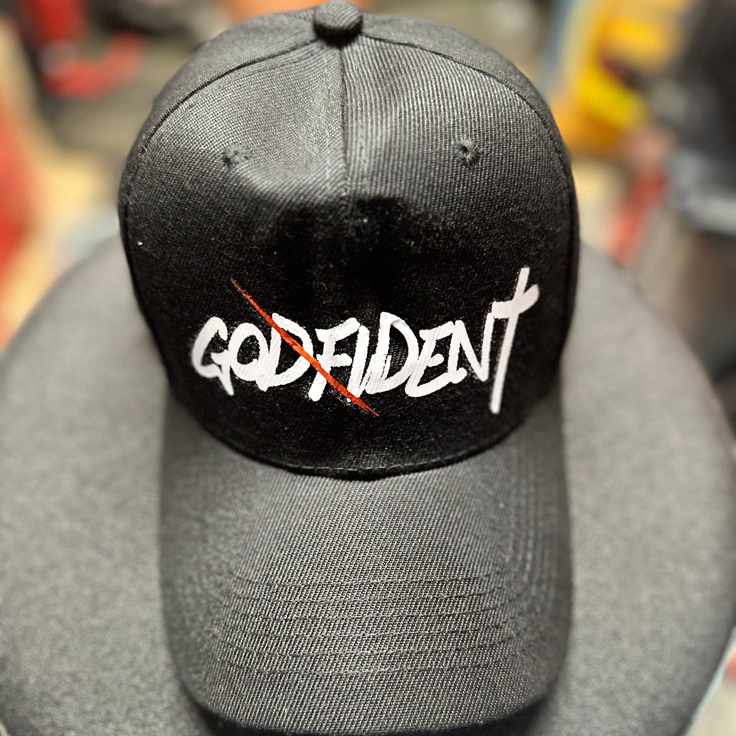 Black cap with white text on a gray surface